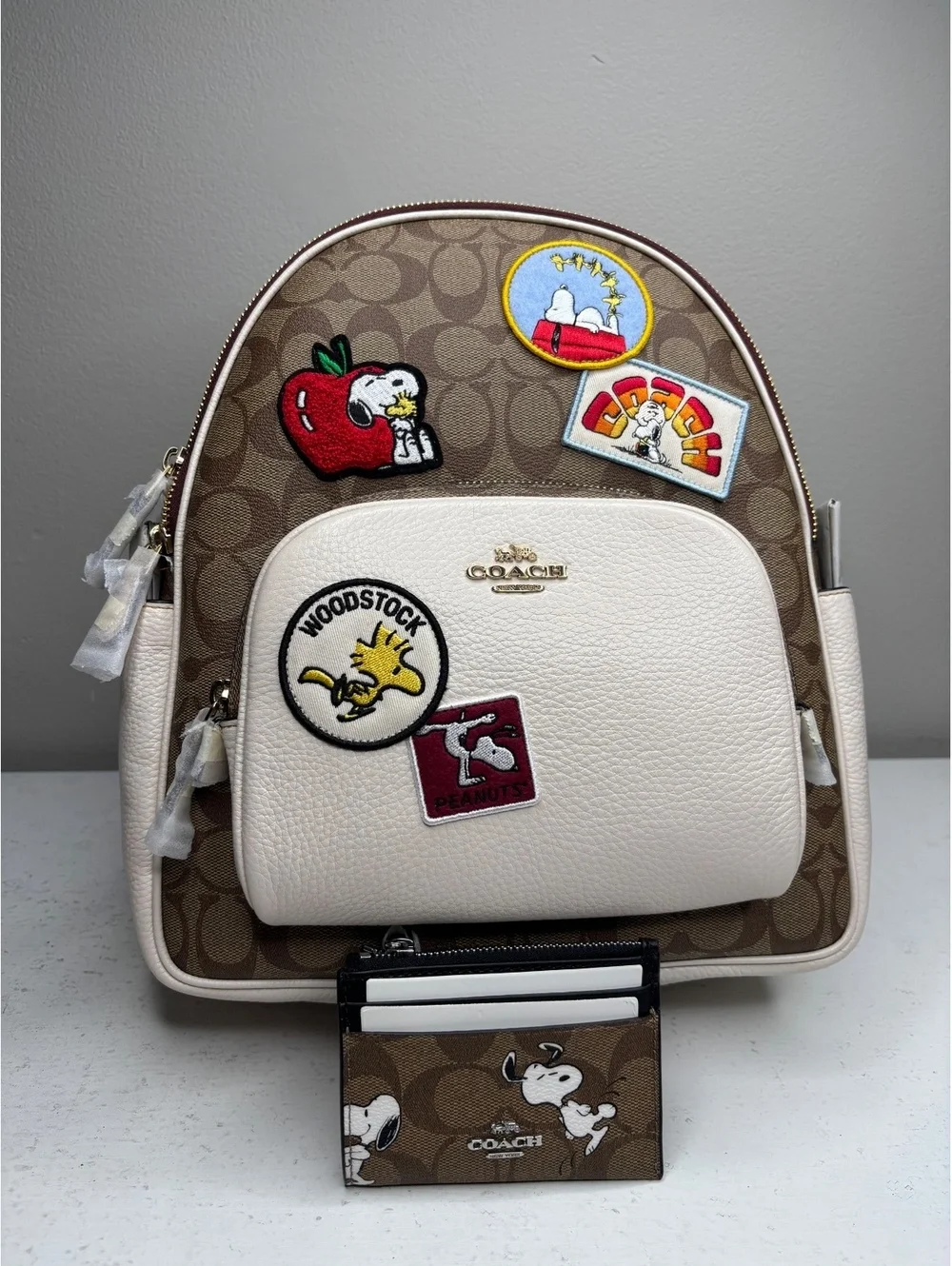 Coach x Peanut Snoopy Backpack Signature Canvas with Varsity Patches & ID Minne
